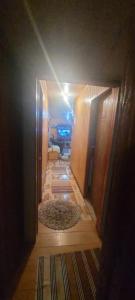 a hallway leading to a room with a rug at Parcela Yolanda en Alto Baguales in Coihaique +10 photos