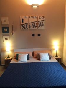 a bedroom with a blue bed with two pillows at Ca' di Bianca in Moneglia