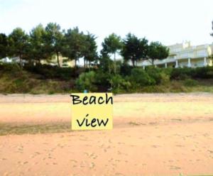 a sign on the beach with the words beach view at Troia Apartments in Troia