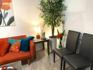 a living room with a couch and two chairs at NEW! 2 minutes from Convention Center, Palms Crossing Shopping & South Texas College in McAllen