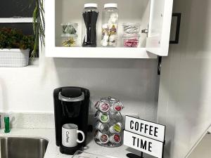 a cupboard with a coffee time sign in a kitchen at NEW! 2 minutes from Convention Center, Palms Crossing Shopping & South Texas College in McAllen
