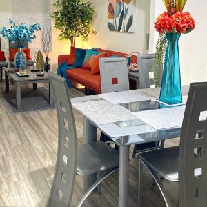 a living room with a table and a couch at NEW! 2 minutes from Convention Center, Palms Crossing Shopping & South Texas College in McAllen