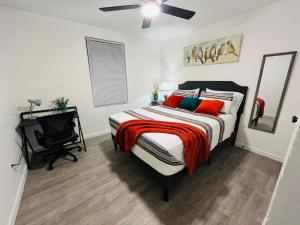 a bedroom with a bed and a desk in it at NEW! 2 minutes from Convention Center, Palms Crossing Shopping & South Texas College in McAllen
