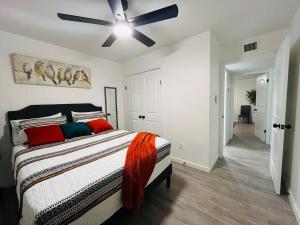 a bedroom with a bed with a ceiling fan at NEW! 2 minutes from Convention Center, Palms Crossing Shopping & South Texas College in McAllen