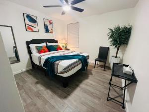 a bedroom with a bed and a ceiling fan at NEW! 2 minutes from Convention Center, Palms Crossing Shopping & South Texas College in McAllen