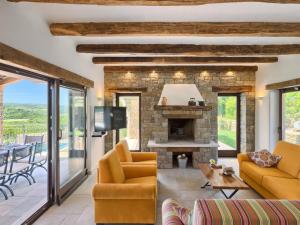 a living room with a couch and a fireplace at Authentic Villa Bani - Four Bedroom Villa With Pool in Livade