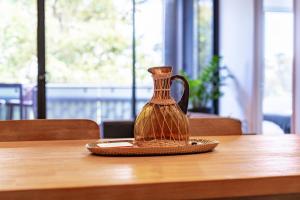 a vase sitting on top of a wooden table at Waterloo 2BR Getaway with Pool & Gym Access in Sydney