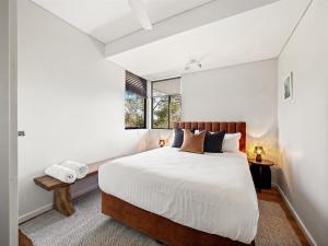 a bedroom with a large bed and a window at Wildflower Ridge in Yallingup