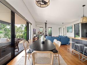a dining room and living room with a table and chairs at Wildflower Ridge in Yallingup
