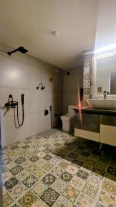 a bathroom with a sink and a tub and a toilet at Quaint village farm stay in Kangra