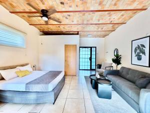 a bedroom with a bed and a couch at Ajijic Retreat Studio with Outdoor Salt Water Pool in Ajijic