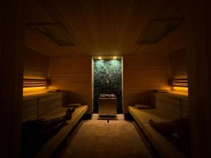 a dark room with benches and a fireplace at Rascals Hotel - Adults Only in Kuta Lombok +37 photos
