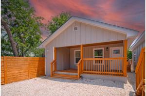 a small shed with a porch and a fence at Your Amazing 3BR2BA Downtown Delight in San Antonio