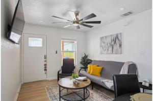 a living room with a couch and a ceiling fan at Your Amazing 3BR2BA Downtown Delight in San Antonio