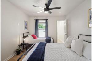 a bedroom with two beds and a ceiling fan at Your Amazing 3BR2BA Downtown Delight in San Antonio