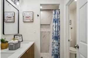 a bathroom with a sink and a shower at Your Amazing 3BR2BA Downtown Delight in San Antonio +33 photos
