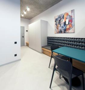 a conference room with a blue table and chairs at Loft студія в Аркадіі з шикарним видом города in Odesa