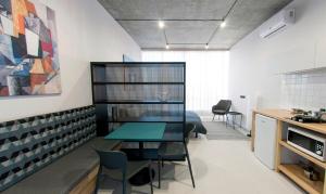a kitchen and dining room with a table and chairs at Loft студія в Аркадіі з шикарним видом города in Odesa +12 photos