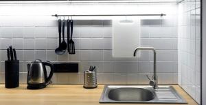 a kitchen counter with a sink and utensils at Loft студія в Аркадіі з шикарним видом города in Odesa