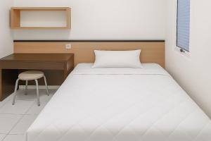 Ένα ή περισσότερα κρεβάτια σε δωμάτιο στο Seladarma Cozy Mitra RedDoorz