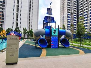a playground with a slide in a park at Horizon Staycation w WiFi in Sepang