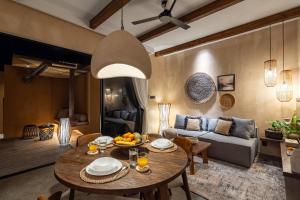 un salon avec une table et un canapé dans l'établissement Nawasena Villa B - Earthy Luxury Villa, Walk to Beach in Pererenan, à Cemagi