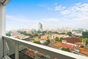 a view of the city from a balcony at Alden by Kozystay - Menteng in Jakarta