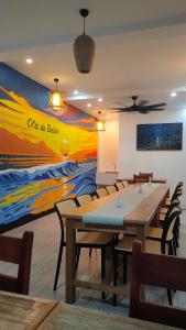 a dining room with a painting on the wall at Ola De Baler in Baler