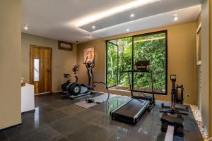 a room with a gym with a large window at Villa Aikyam in Tegalalang