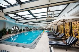 a large swimming pool with lounge chairs and an indoor swimming pool at Vinpearl Resort & Spa Ha Long in Ha Long +88 photos