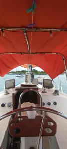 a boat with a red canopy on the water at Sv Lukas in Bocas del Toro