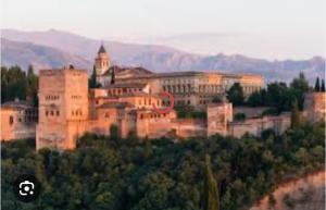a large castle in the middle of a forest at Encarnita Apartamento - Monachil in Monachil