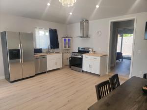 a kitchen with stainless steel appliances and a dining table at Casa One in Winnetka +11 photos