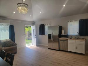 a kitchen with a stainless steel refrigerator and a couch at Casa One in Winnetka