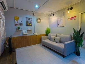 a waiting room with a couch and a waiting desk at Natasha RestHouse in Pulau Langkawi