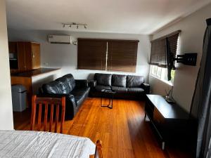 a living room with a couch and a table at Cedar Lookout in Brisbane