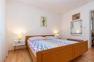 a bedroom with a large bed with a wooden frame at Haus Valerija in Labin