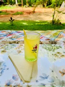 a glass of orange juice sitting on a table at Royal Breeze Resort Sigiriya in Sigiriya