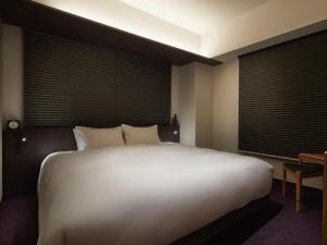 Postel nebo postele na pokoji v ubytování Agora Kyoto Shijo