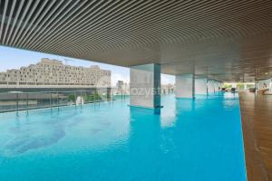 a large pool of blue water in a building at Alden by Kozystay - Menteng in Jakarta