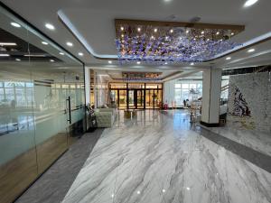 a lobby with a chandelier and marble floors and a building at Numt Guren Resort in Ulaanbaatar
