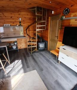 a living room with a staircase in a log cabin at Saulkrasti Beach Cottage 2 in Saulkrasti +6 photos