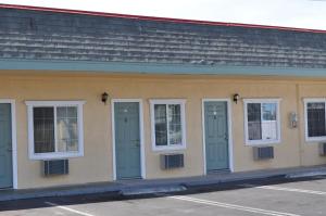 a building with blue doors and windows on it at The Palace Inn in Oxnard