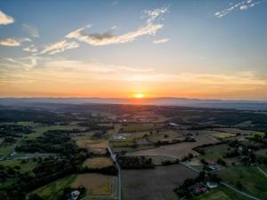 an aerial view of a sunset over a city at au gite de la cascade in Le Grand Serre