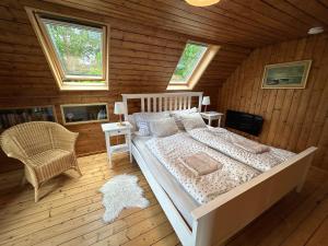 a bedroom with a bed in a log cabin at Chalupa u Lacinů in Mirošovice
