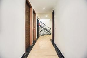 a hallway with white walls and a stairway at Super Collection O Amritsar Near Railway Station in Amritsar