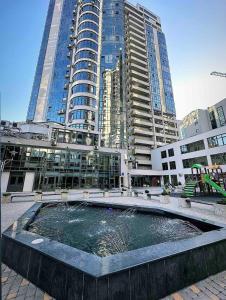 a fountain in front of a building with tall buildings at Loft студія в Аркадіі з шикарним видом города in Odesa