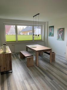 a room with a wooden table and benches in it at Möbliertes Wohnen auf Zeit im Extertal in Extertal