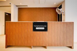 a sign that reads town house on a wooden wall at Super Townhouse T Block Sector 24 in Gurgaon
