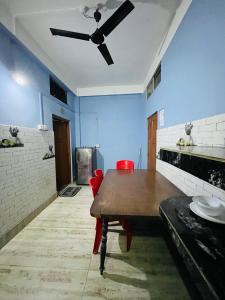 a dining room with a table and a ceiling fan at SANGRAG Homestay in Guwahati